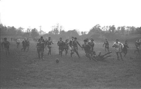 Inter house rugby match c.1960<br> A wintry scene, sodden ground, with Fairoaks airfield in the background, the hooped jerseys are one of the visiting teams the school would play from time to time.  © Mike Leggett
