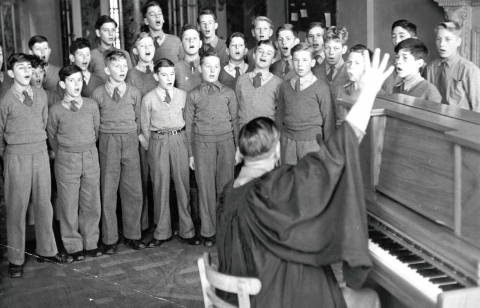 Choir practice under Mr Tolley<br>L – R. Front row. Haskell, Reynolds, Welfare, Calvert, Clarke, Phillips, Prater, Whycherly (behind hand), Harmes. Second row. Humphries, Greenland, Harding, Gaskin, Tuckett, Lord, Eade, Cain, Darbyshire, Smith. Third row. Dobson, Edge.D, Lamerton, Collier, Gurney